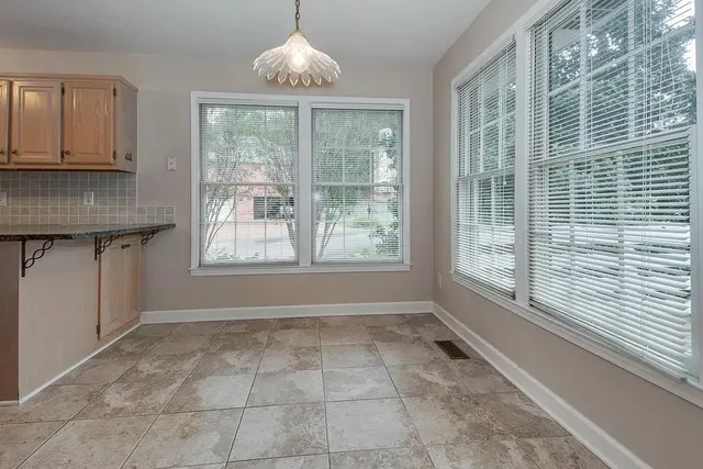 a living room with a fireplace and windows