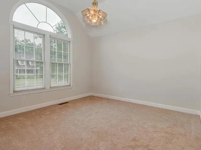a spacious bathroom with a tub sink and mirror