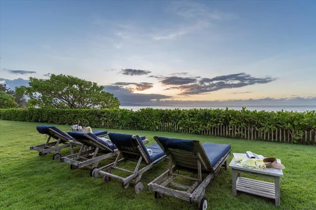 an outdoor sitting area with furniture and garden
