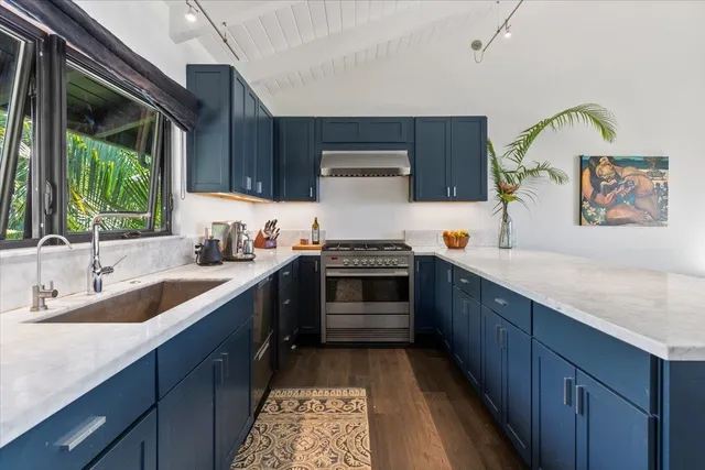 a kitchen with a sink stove and cabinets