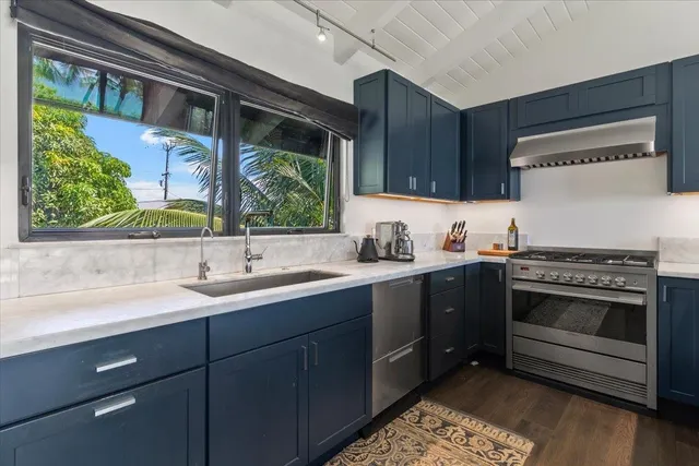 a kitchen with a sink stove and cabinets
