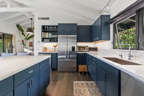 a kitchen with granite countertop a sink stainless steel appliances and cabinets