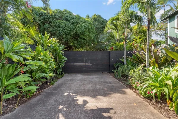 a view of backyard with a deck and a garden