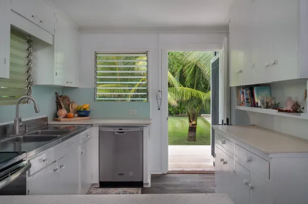 a bathroom with a granite countertop toilet sink and mirror