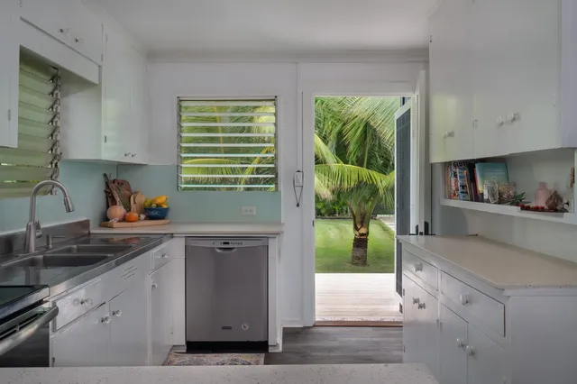 a bathroom with a granite countertop toilet sink and mirror