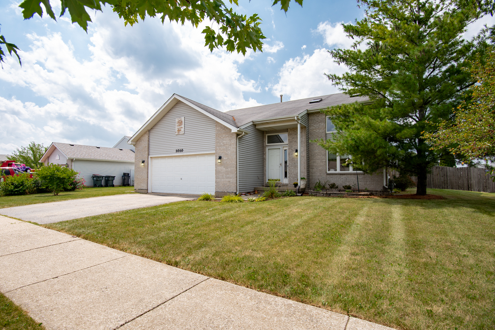 1010 Pheasant Run Zion, IL 60099 - Photo 2 of 4 a front view of house with yard and trees