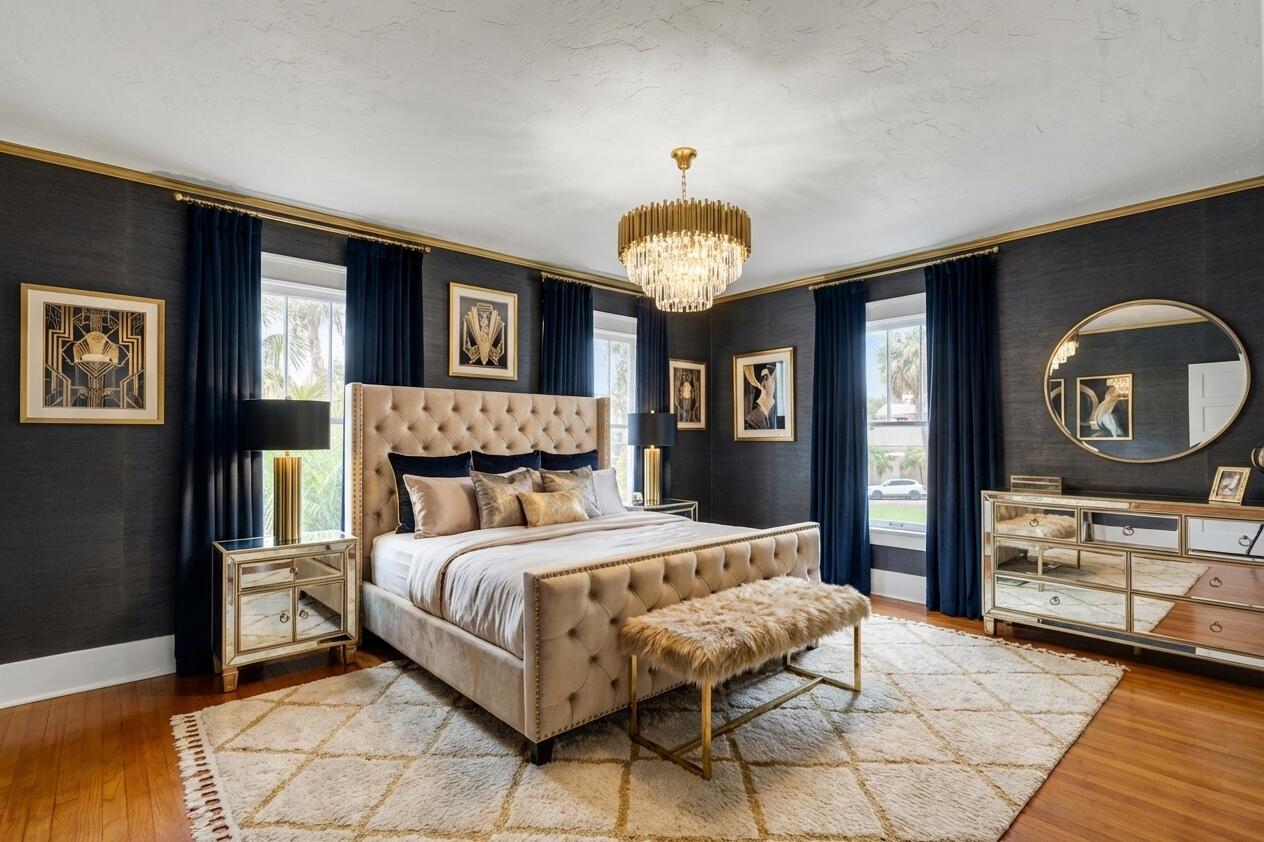 322 Westminster Road West Palm Beach, FL 33405 - Photo 34 of 68 a bedroom with a bed and a chandelier