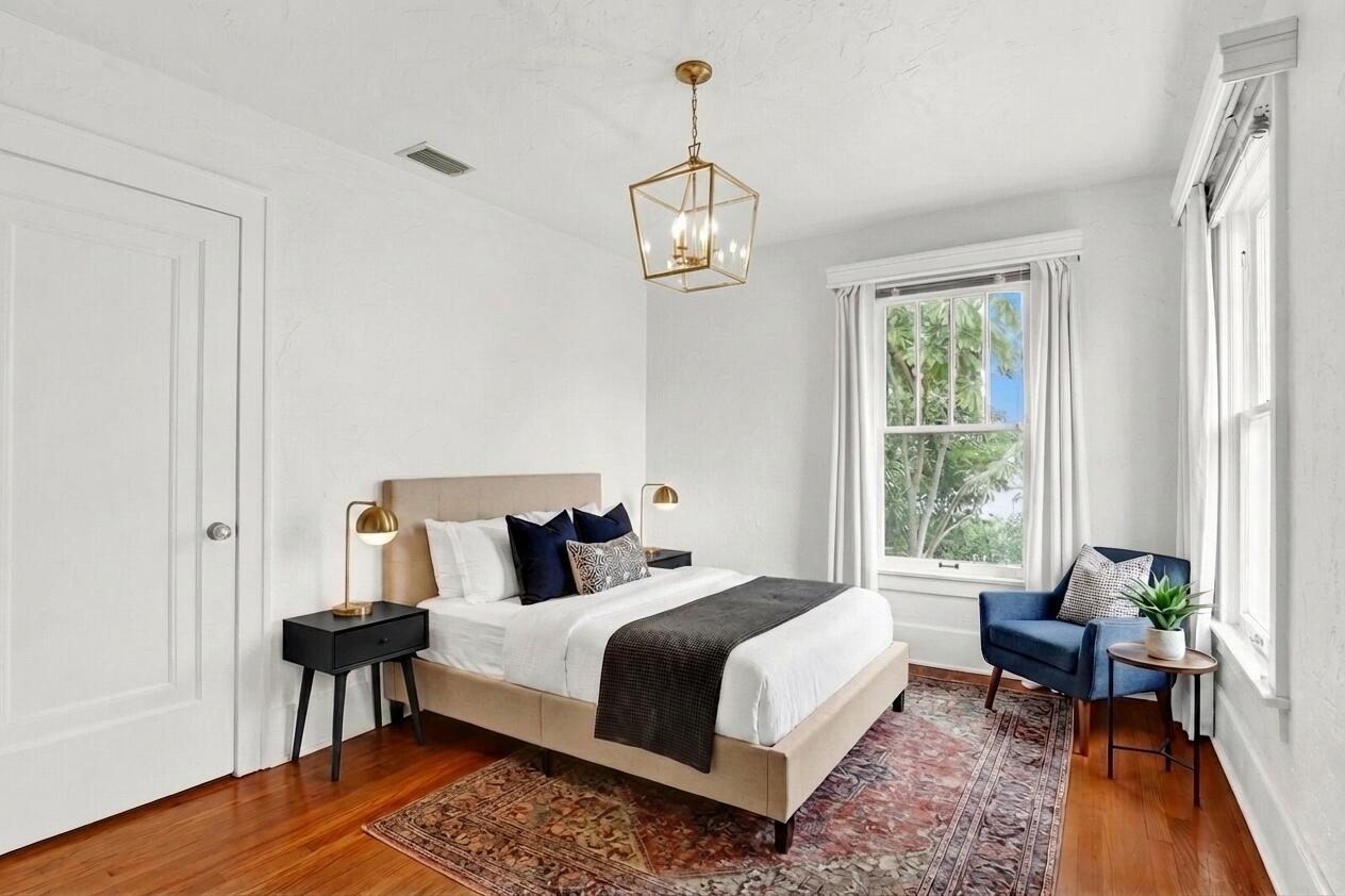 322 Westminster Road West Palm Beach, FL 33405 - Photo 38 of 68 a bedroom with a bed wooden floor and a window