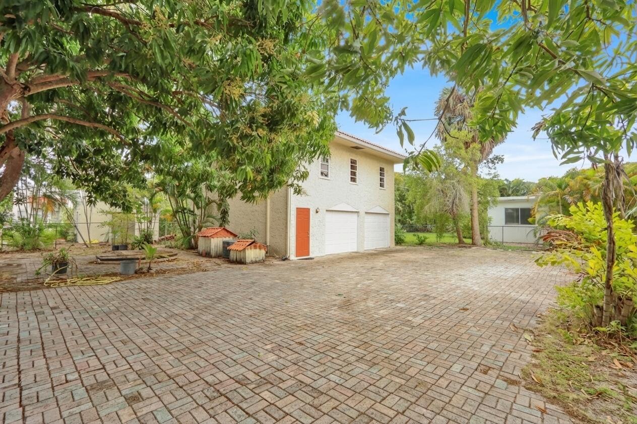 322 Westminster Road West Palm Beach, FL 33405 - Photo 58 of 68 a view of a house with a yard and garage