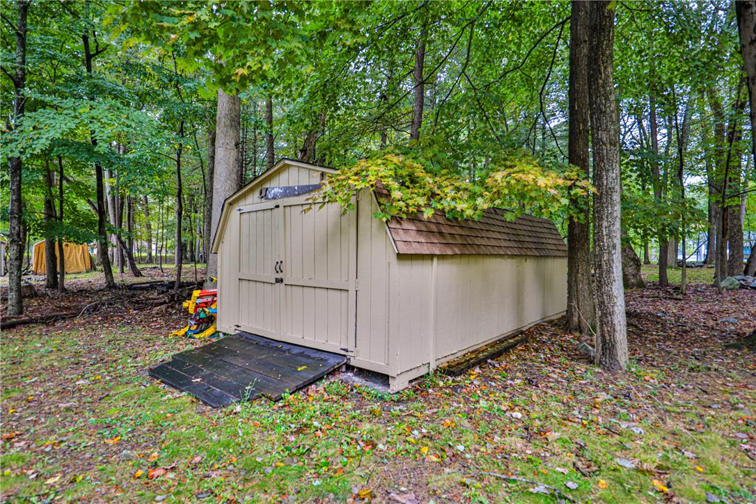 24 Turkey Ridge Road East Stroudsburg, PA 18302 - Photo 29 of 34 Tucked among mature trees, a practical storage shed provides excellent utility on the property.