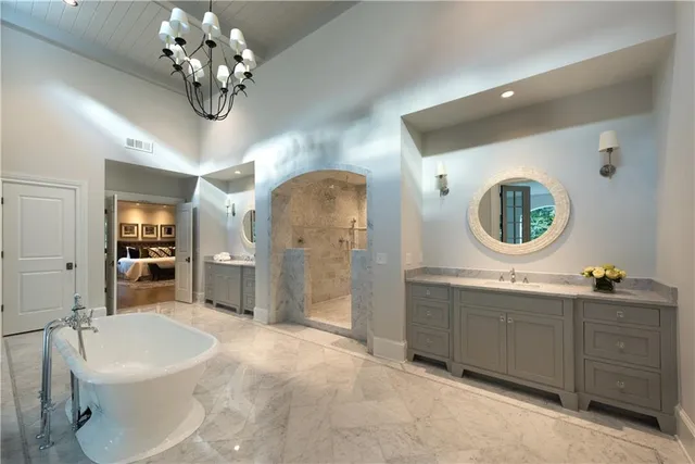 a spacious bathroom with a double vanity sink and a mirror