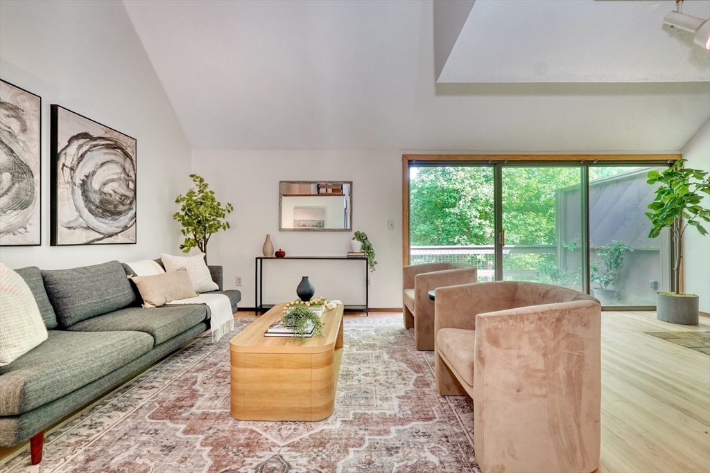 422 Great Elm Way, Unit 422 Acton, MA 01718 - Photo 11 of 30 a living room with furniture and a large window
