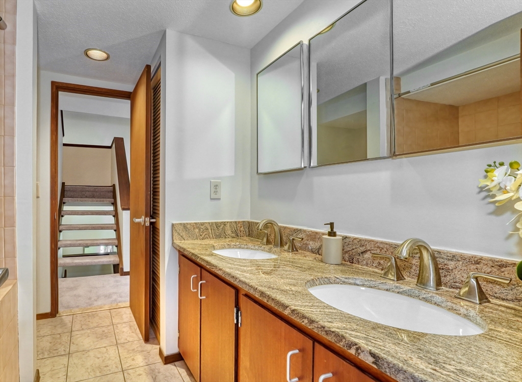 422 Great Elm Way, Unit 422 Acton, MA 01718 - Photo 14 of 30 a bathroom with a granite countertop sink and a mirror