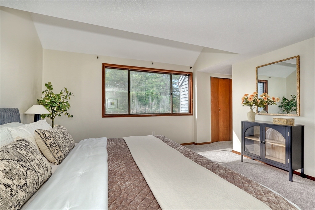 422 Great Elm Way, Unit 422 Acton, MA 01718 - Photo 17 of 30 a bedroom with a bed and a window