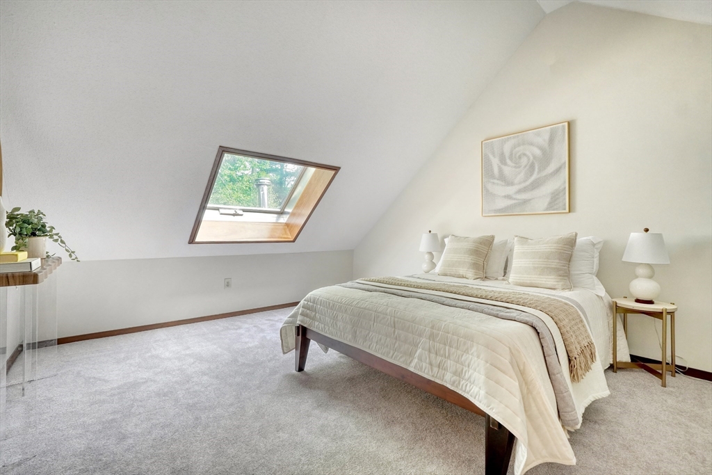 422 Great Elm Way, Unit 422 Acton, MA 01718 - Photo 20 of 30 a spacious bedroom with a bed and a window