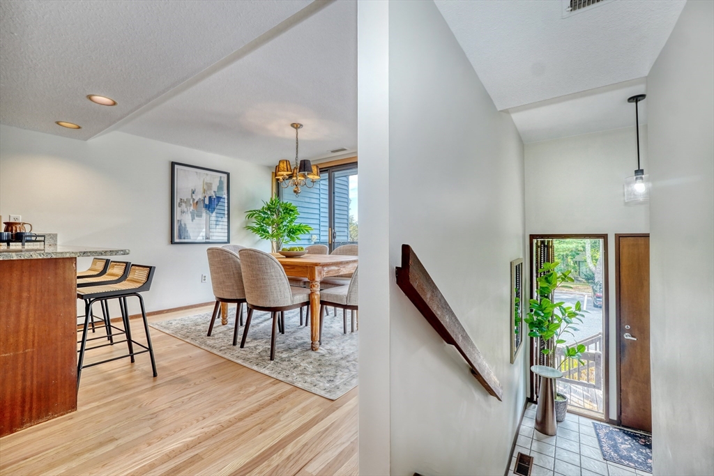 422 Great Elm Way, Unit 422 Acton, MA 01718 - Photo 2 of 30 a view of a dining room with furniture and wooden floor