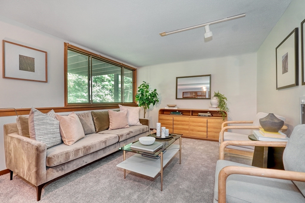 422 Great Elm Way, Unit 422 Acton, MA 01718 - Photo 22 of 30 a living room with furniture and a large window