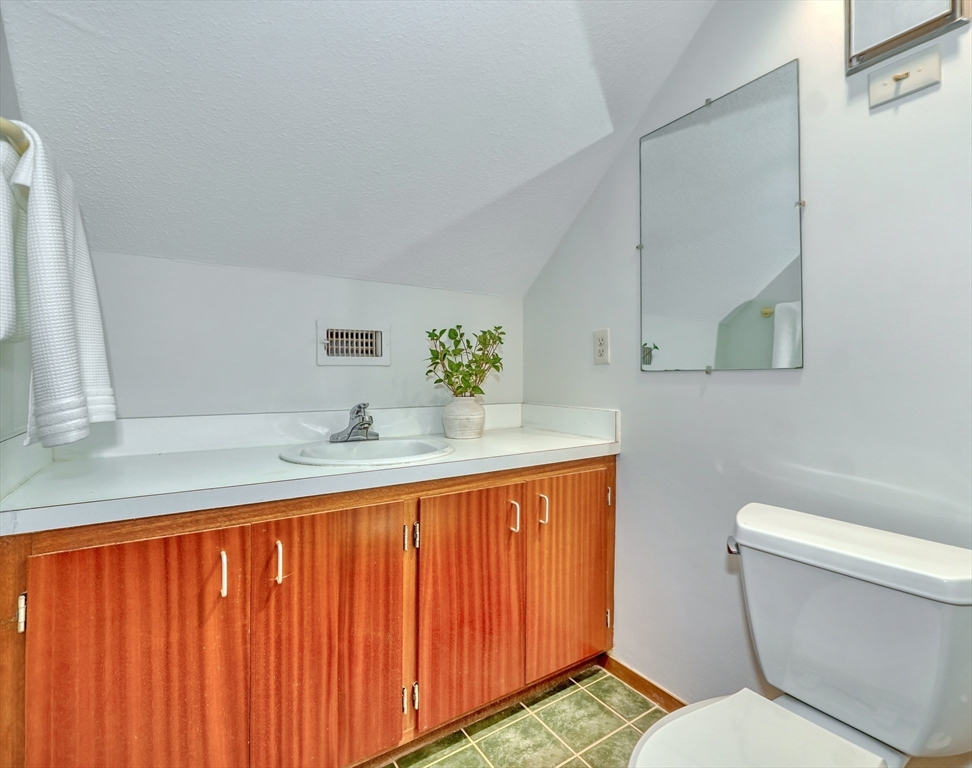 422 Great Elm Way, Unit 422 Acton, MA 01718 - Photo 24 of 30 a bathroom with a sink a toilet and vanity