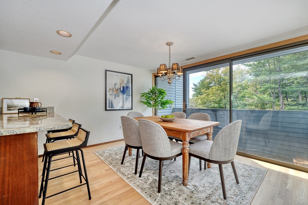 422 Great Elm Way, Unit 422 Acton, MA 01718 - Photo 4 of 30 a view of a dining room with furniture window and outside view