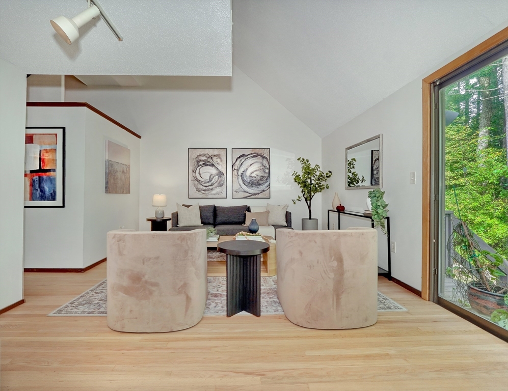 422 Great Elm Way, Unit 422 Acton, MA 01718 - Photo 7 of 30 a living room with fireplace furniture and a large window