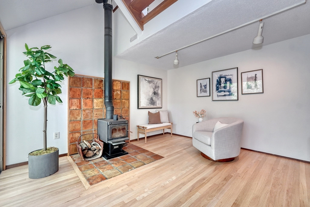 422 Great Elm Way, Unit 422 Acton, MA 01718 - Photo 9 of 30 a living room with furniture and a potted plant