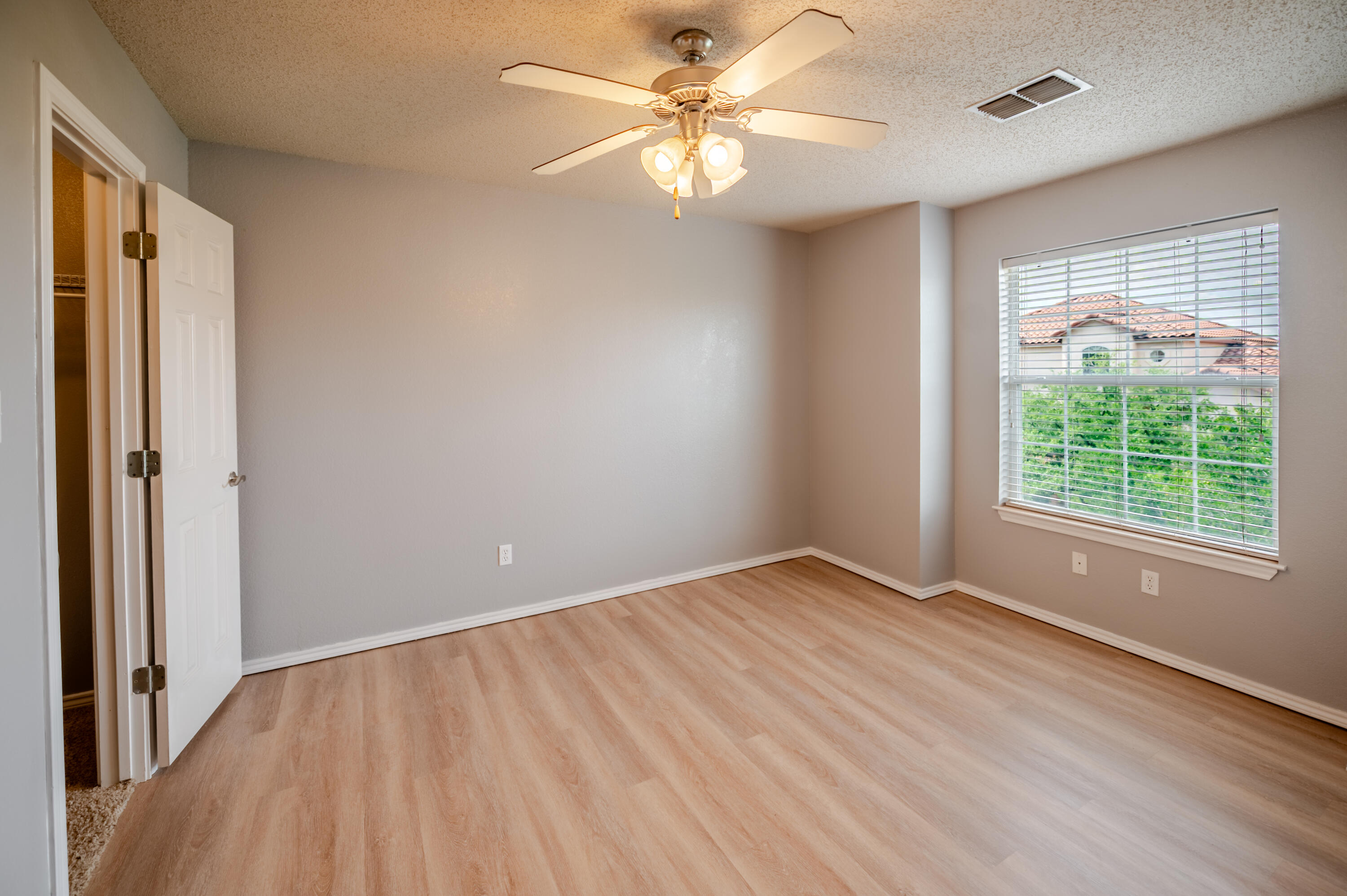 2111 Main Street, Unit 1 Lubbock, TX 79401 - Photo 18 of 36 wooden floor in an empty room with a window