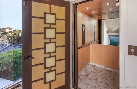 view of a bathroom with a glass door shower and a sink