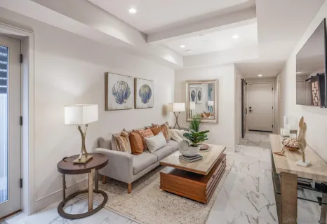 a living room with furniture and a potted plant