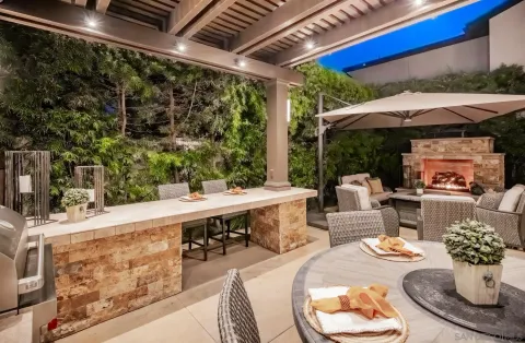a outdoor dining space with furniture and umbrella