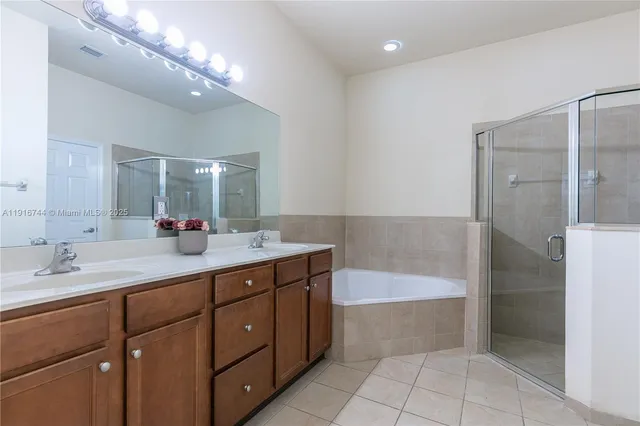 a bathroom with a shower sink and mirror
