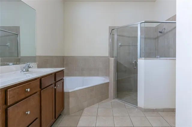 a bathroom with a tub sink and mirror