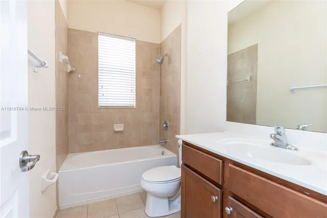 a bathroom with a sink toilet vanity and bathtub