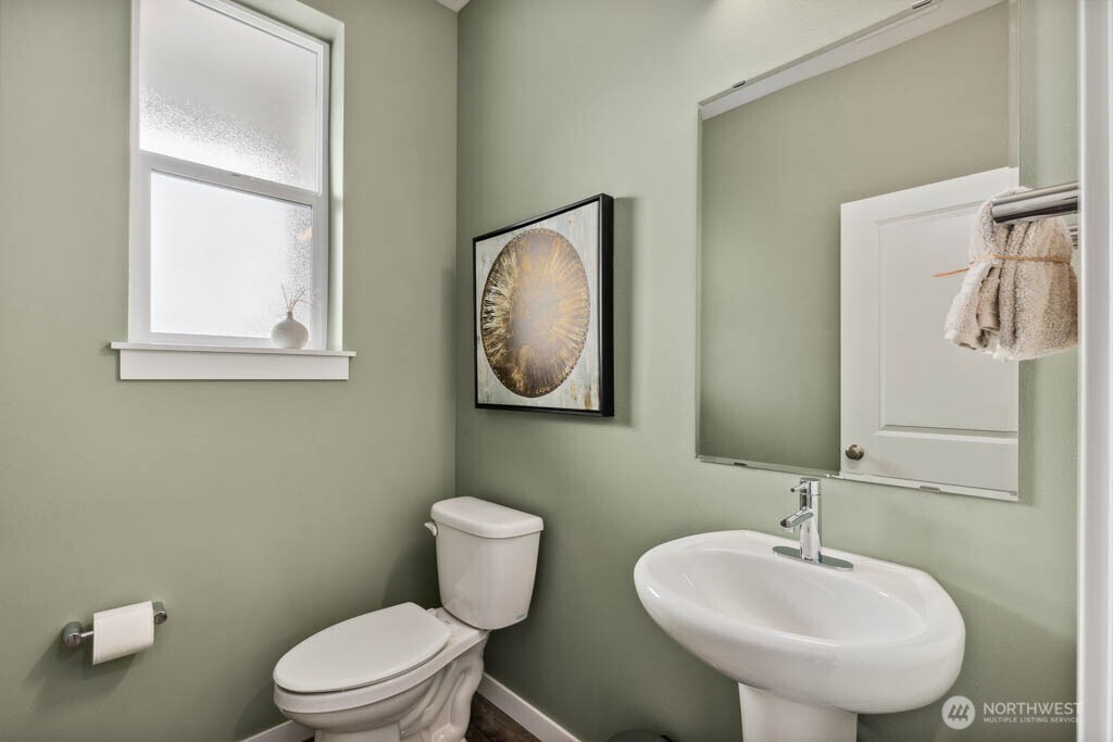 3807 194th Place Southeast Bothell, WA 98012 - Photo 2 of 21 a bathroom with a toilet a sink and mirror