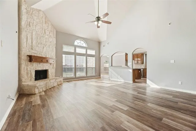 a view of a livingroom with wooden floor and a ceiling fan