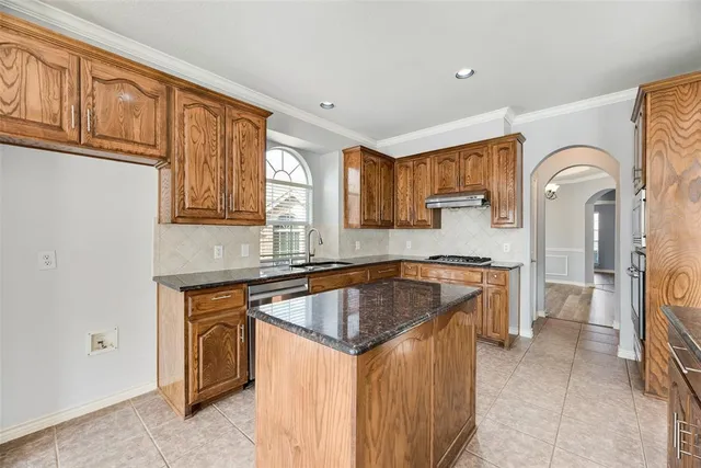 a kitchen that has a sink and a stove in it