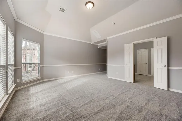 an empty room with windows and closet