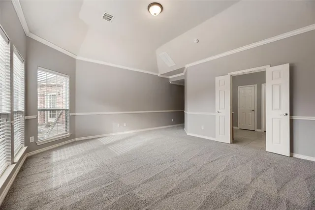 an empty room with windows and closet