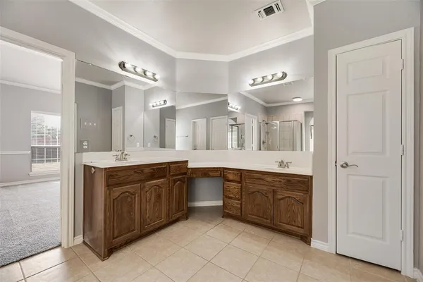 a large bathroom with a large mirror vanity and double
