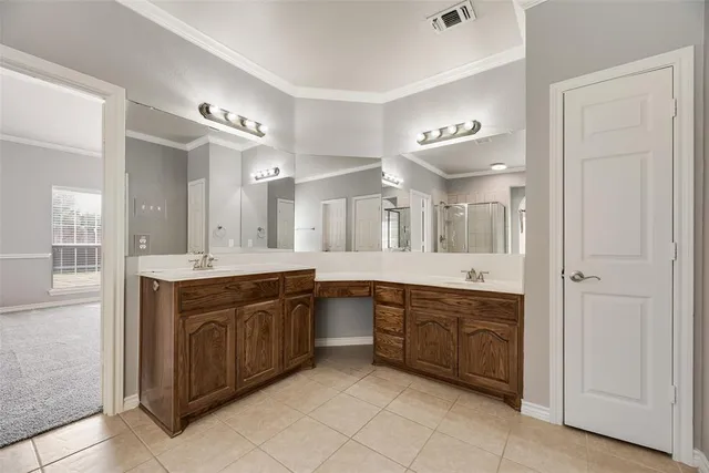 a large bathroom with a large mirror vanity and double
