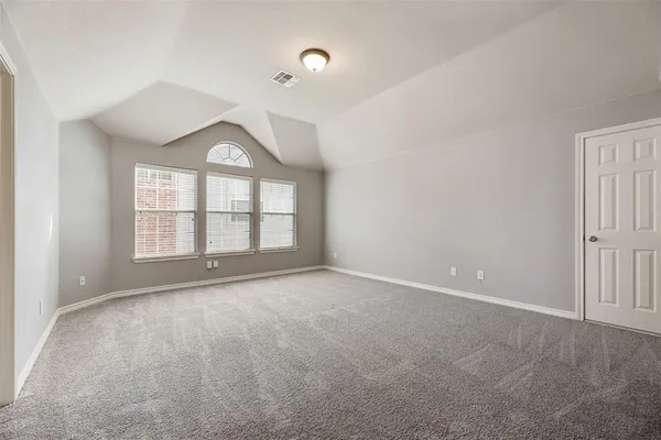 an empty room with a empty space and windows