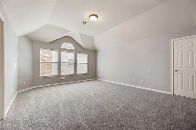 an empty room with a empty space and windows