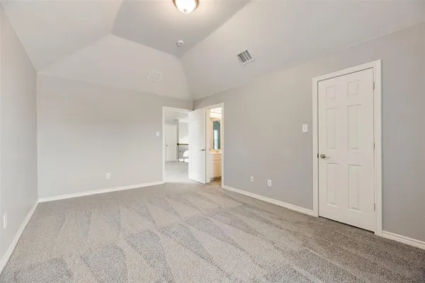 wooden floor in a room with a bathroom