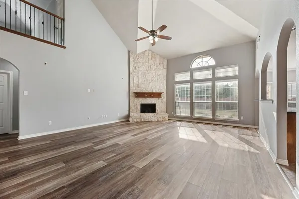 a view of an empty room with a fireplace and a window