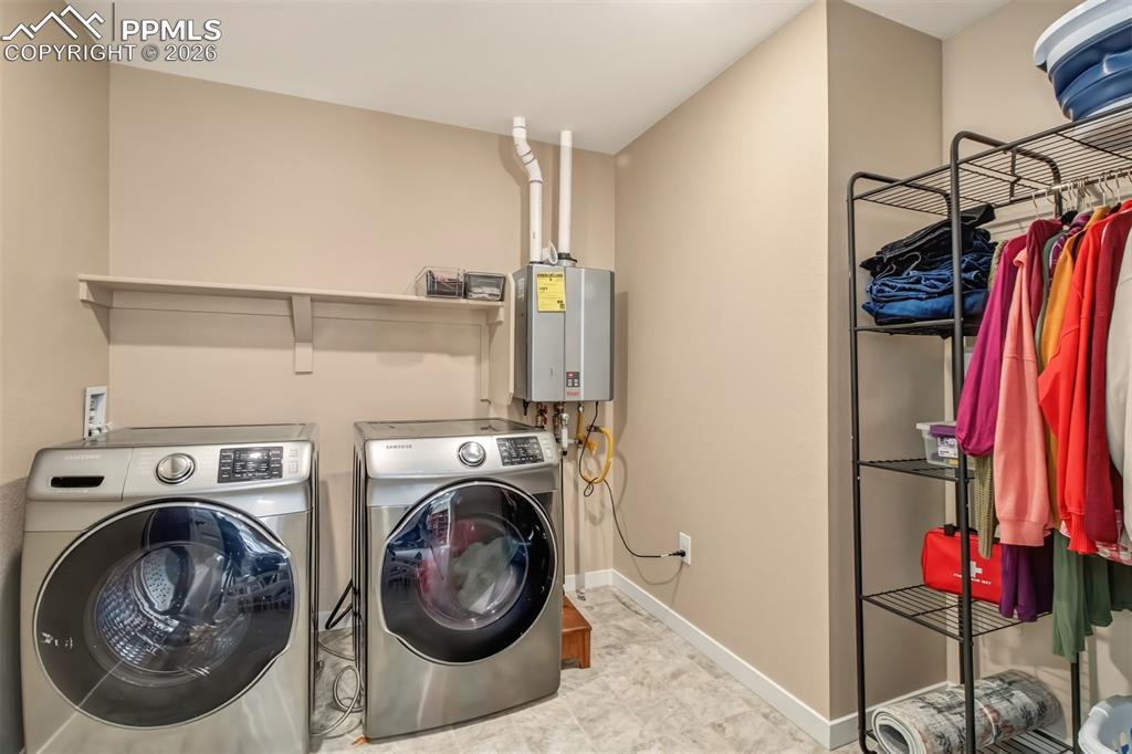6133 Alpine Ridge Drive Colorado Springs, CO 80925 - Photo 13 of 31 a utility room with dryer and washer
