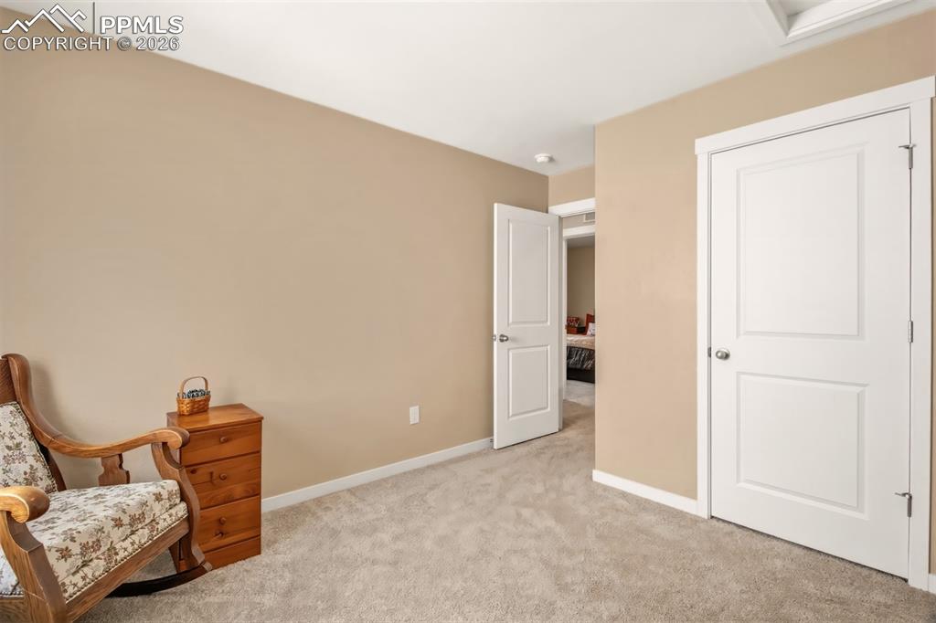6133 Alpine Ridge Drive Colorado Springs, CO 80925 - Photo 17 of 31 a view of room with furniture and a ceiling fan