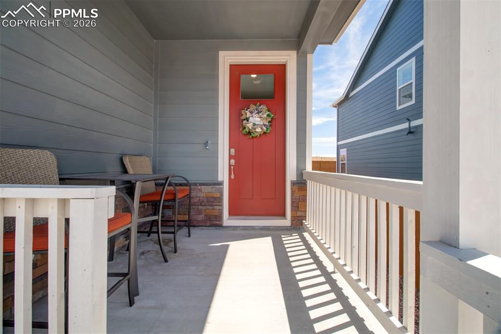 6133 Alpine Ridge Drive Colorado Springs, CO 80925 - Photo 2 of 31 a view of a hallway with wooden floor and stairs
