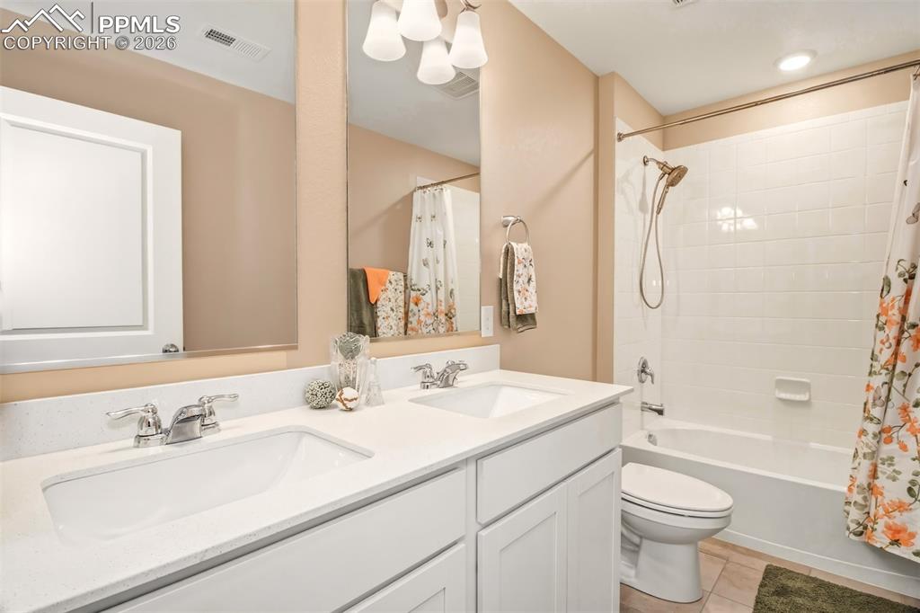 6133 Alpine Ridge Drive Colorado Springs, CO 80925 - Photo 22 of 31 a bathroom with a sink a toilet and shower