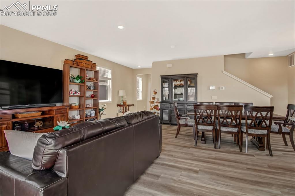 6133 Alpine Ridge Drive Colorado Springs, CO 80925 - Photo 3 of 31 a living room with furniture a flat screen tv and floor to ceiling window