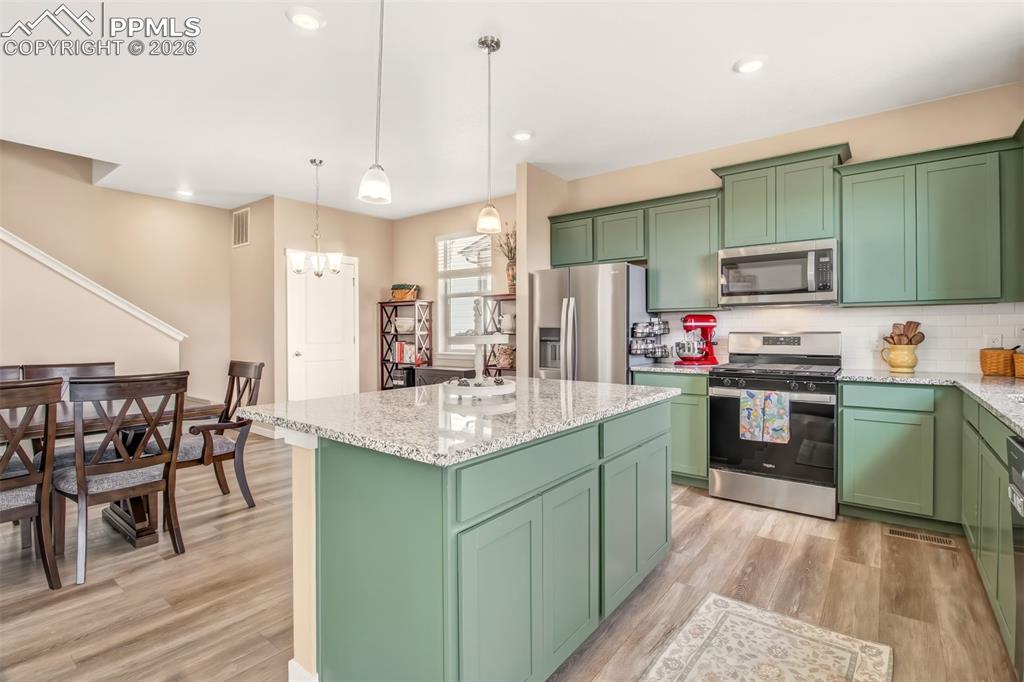 6133 Alpine Ridge Drive Colorado Springs, CO 80925 - Photo 5 of 31 a kitchen with sink cabinets and stainless steel appliances