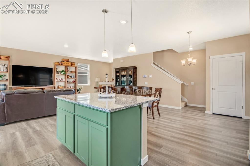 6133 Alpine Ridge Drive Colorado Springs, CO 80925 - Photo 6 of 31 a kitchen with stainless steel appliances kitchen island a large island in the center